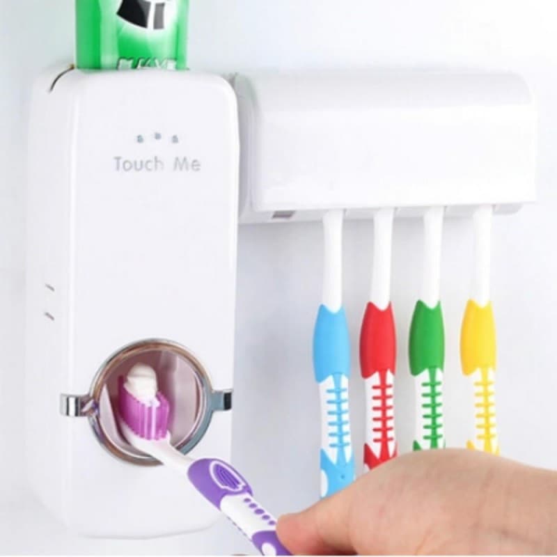 Wall-mounted toothpaste dispenser releasing paste onto a toothbrush